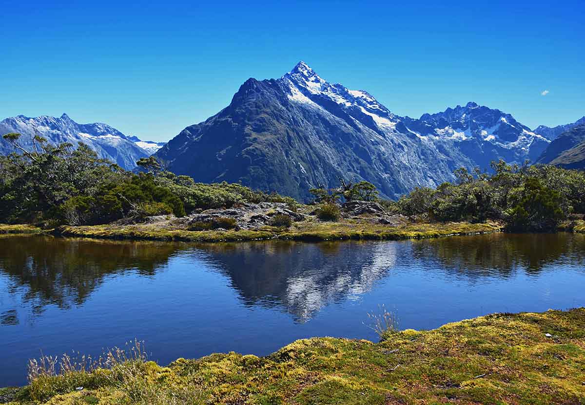 Routeburn track lake and mountain peak