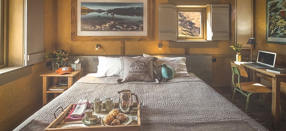 Bed and bedroom inside a cabin at Headwaters Camp Glenorchy