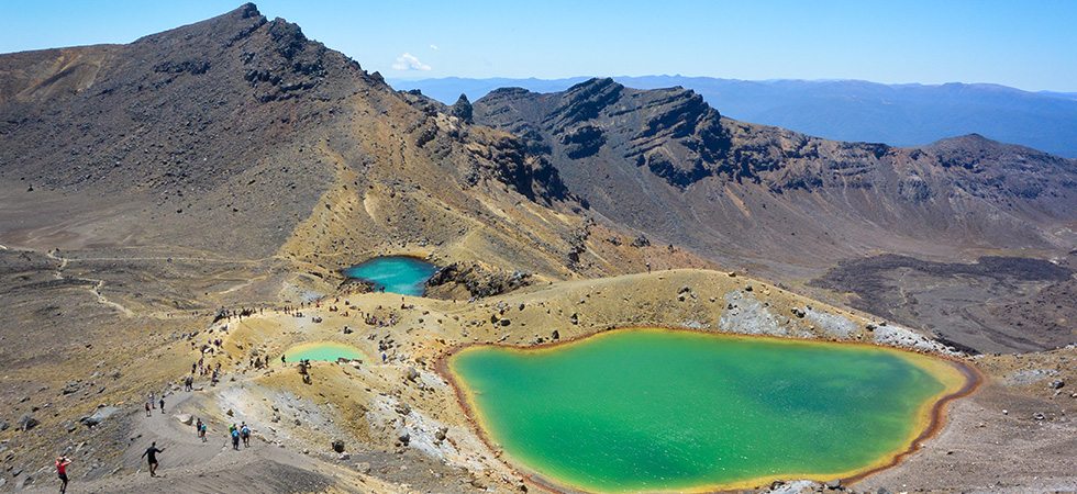 Hikers walking near emerald lakes on the Tongariro Crossing